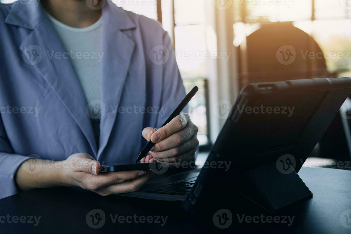 Asian Business woman using calculator and laptop for doing math finance on an office desk, tax, report, accounting, statistics, and analytical research concept photo