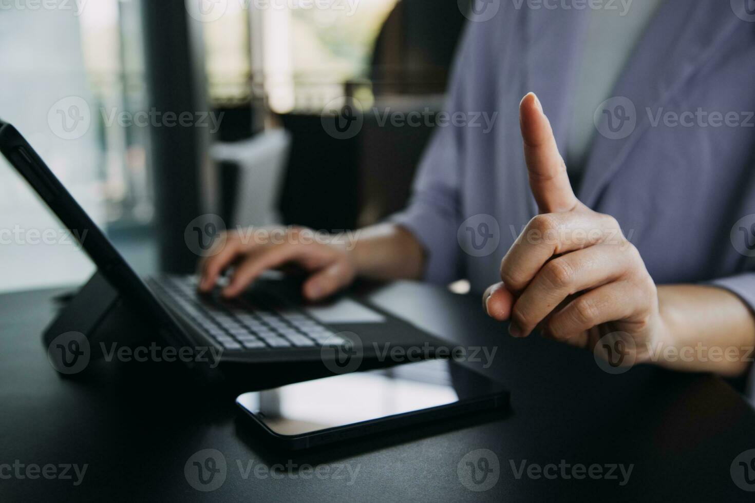 Asian Business woman using calculator and laptop for doing math finance on an office desk, tax, report, accounting, statistics, and analytical research concept photo