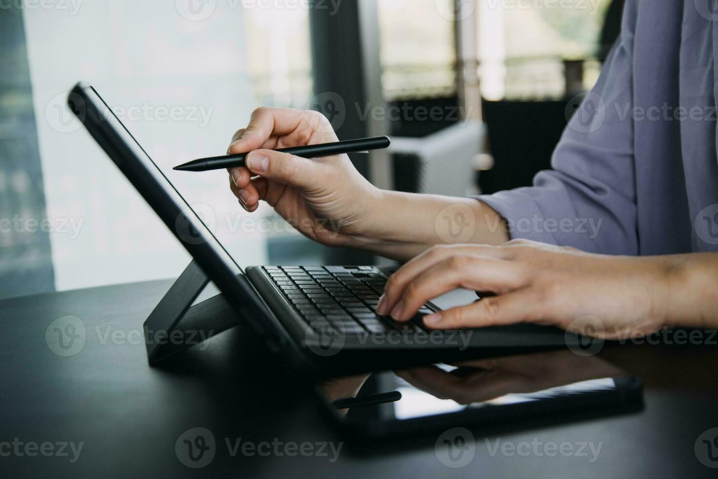 Asian Business woman using calculator and laptop for doing math finance on an office desk, tax, report, accounting, statistics, and analytical research concept photo