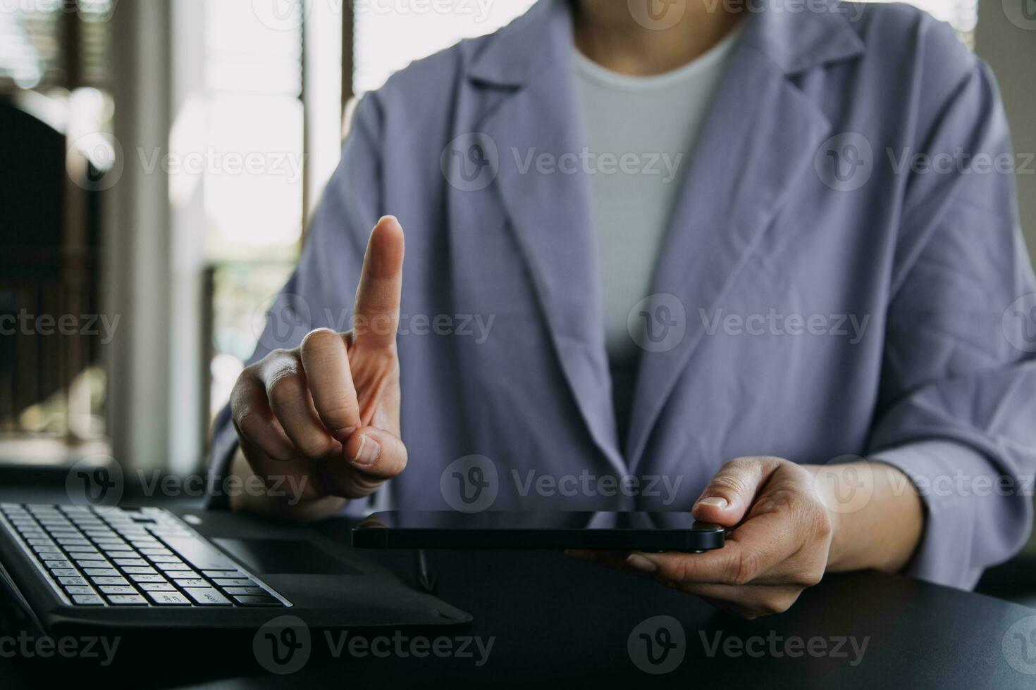 Asian Business woman using calculator and laptop for doing math finance on an office desk, tax, report, accounting, statistics, and analytical research concept photo
