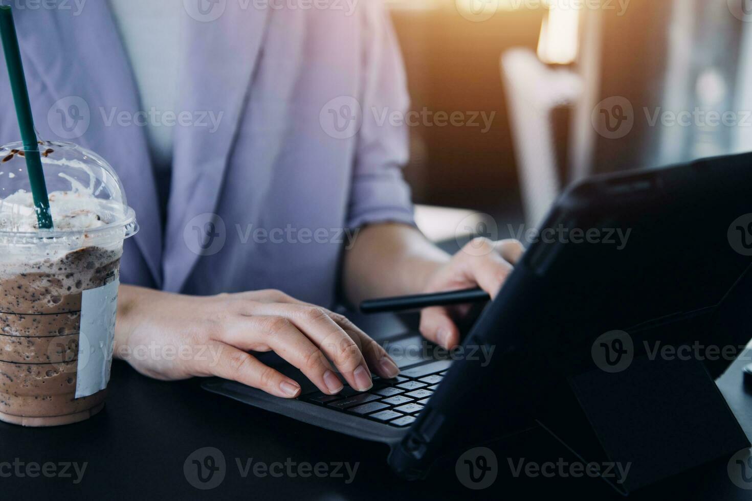 Asian Business woman using calculator and laptop for doing math finance on an office desk, tax, report, accounting, statistics, and analytical research concept photo