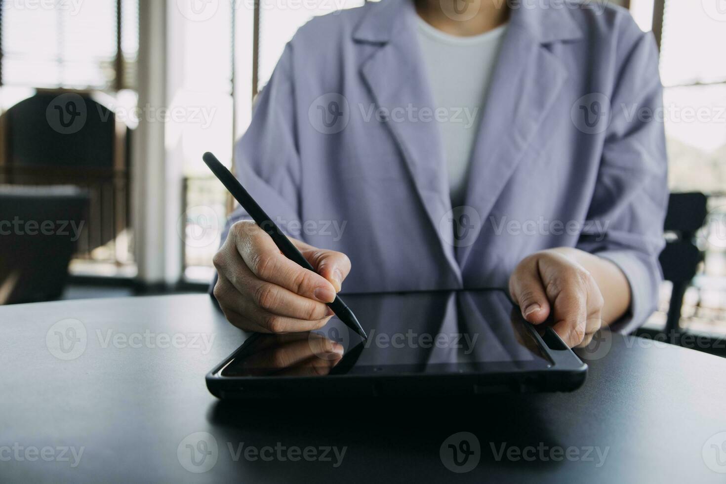 Asian Business woman using calculator and laptop for doing math finance on an office desk, tax, report, accounting, statistics, and analytical research concept photo