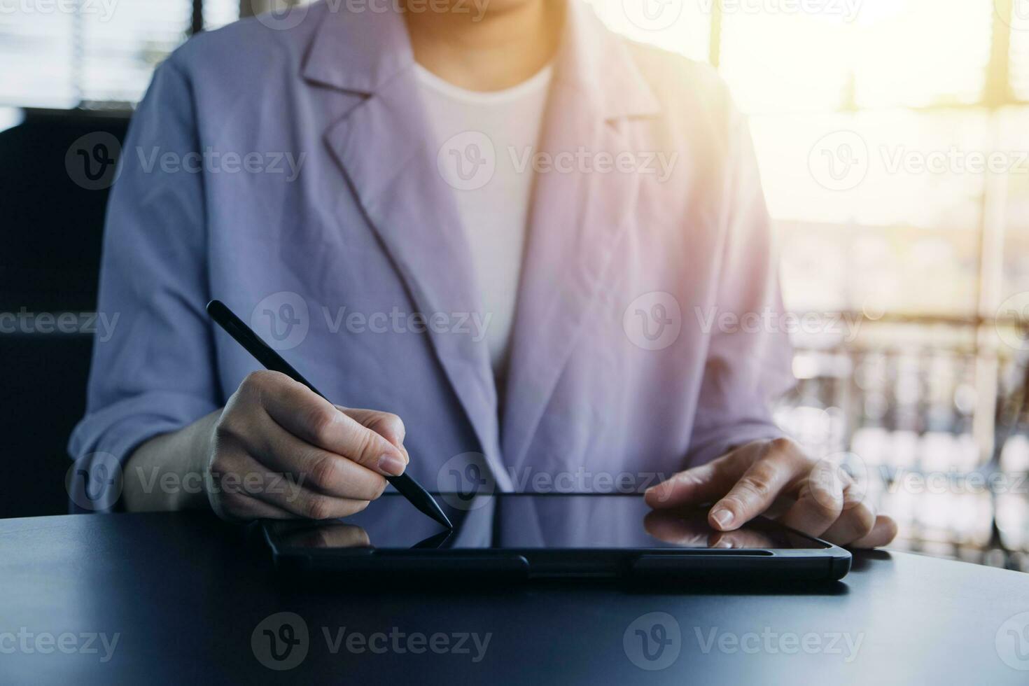 Asian Business woman using calculator and laptop for doing math finance on an office desk, tax, report, accounting, statistics, and analytical research concept photo