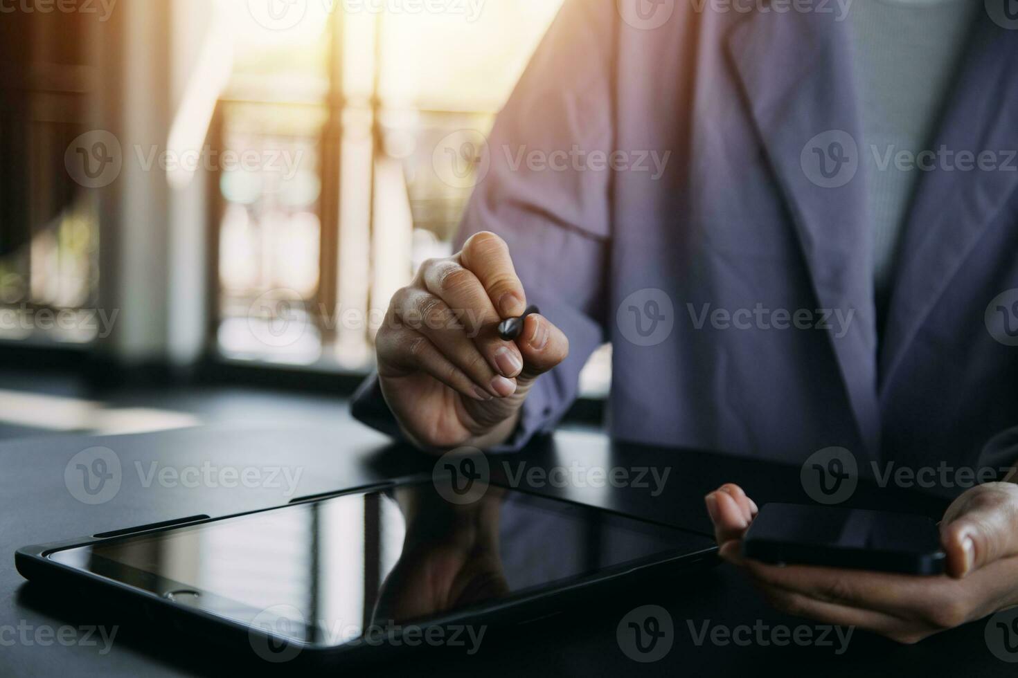 Asian Business woman using calculator and laptop for doing math finance on an office desk, tax, report, accounting, statistics, and analytical research concept photo