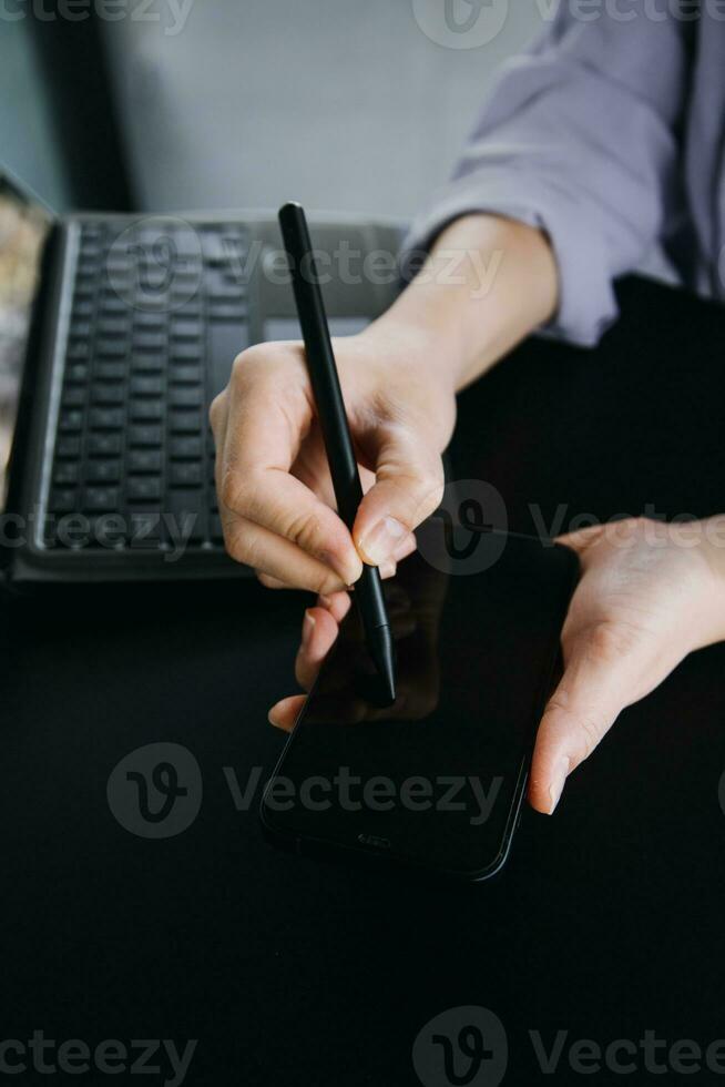 Asian Business woman using calculator and laptop for doing math finance on an office desk, tax, report, accounting, statistics, and analytical research concept photo