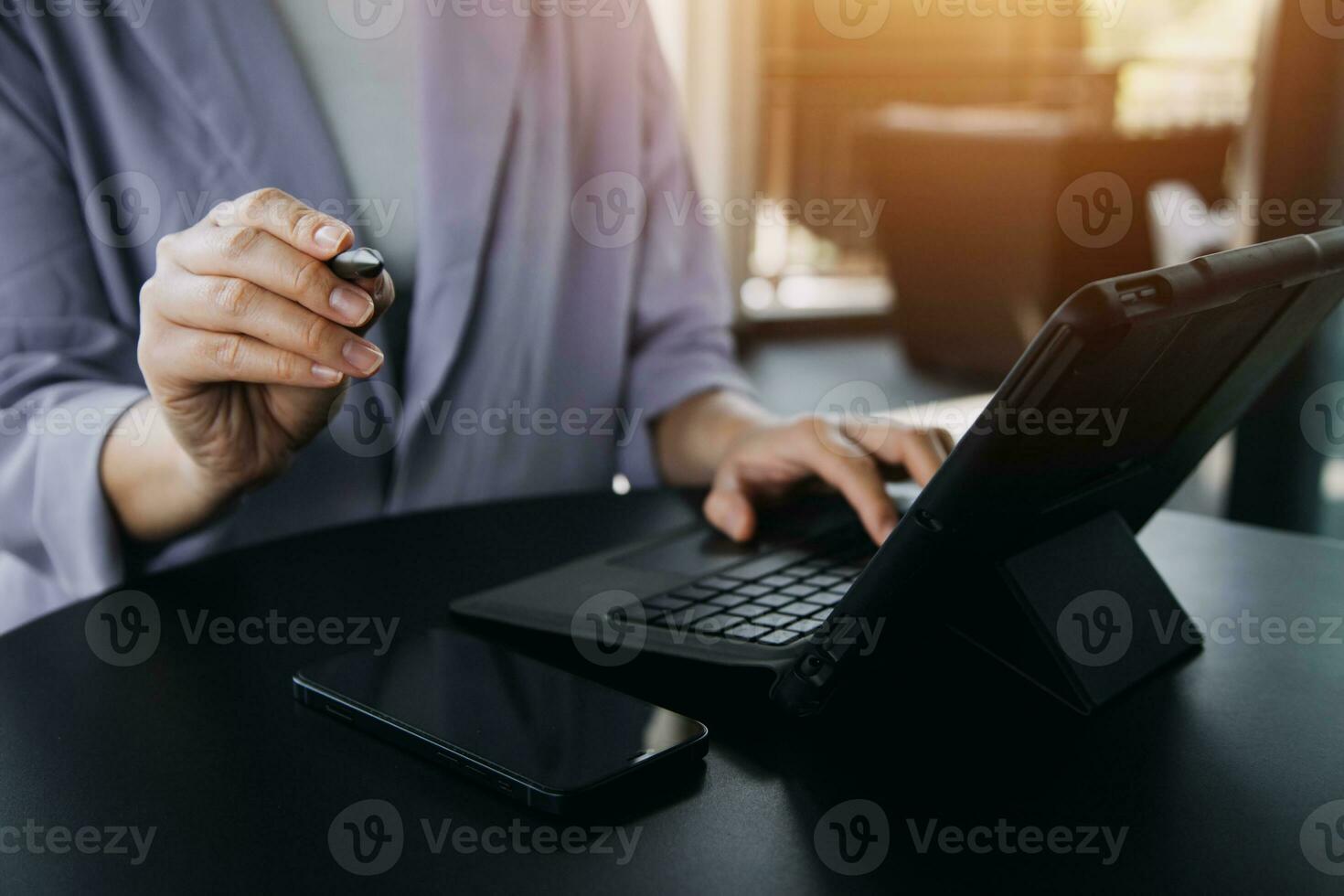 Asian Business woman using calculator and laptop for doing math finance on an office desk, tax, report, accounting, statistics, and analytical research concept photo