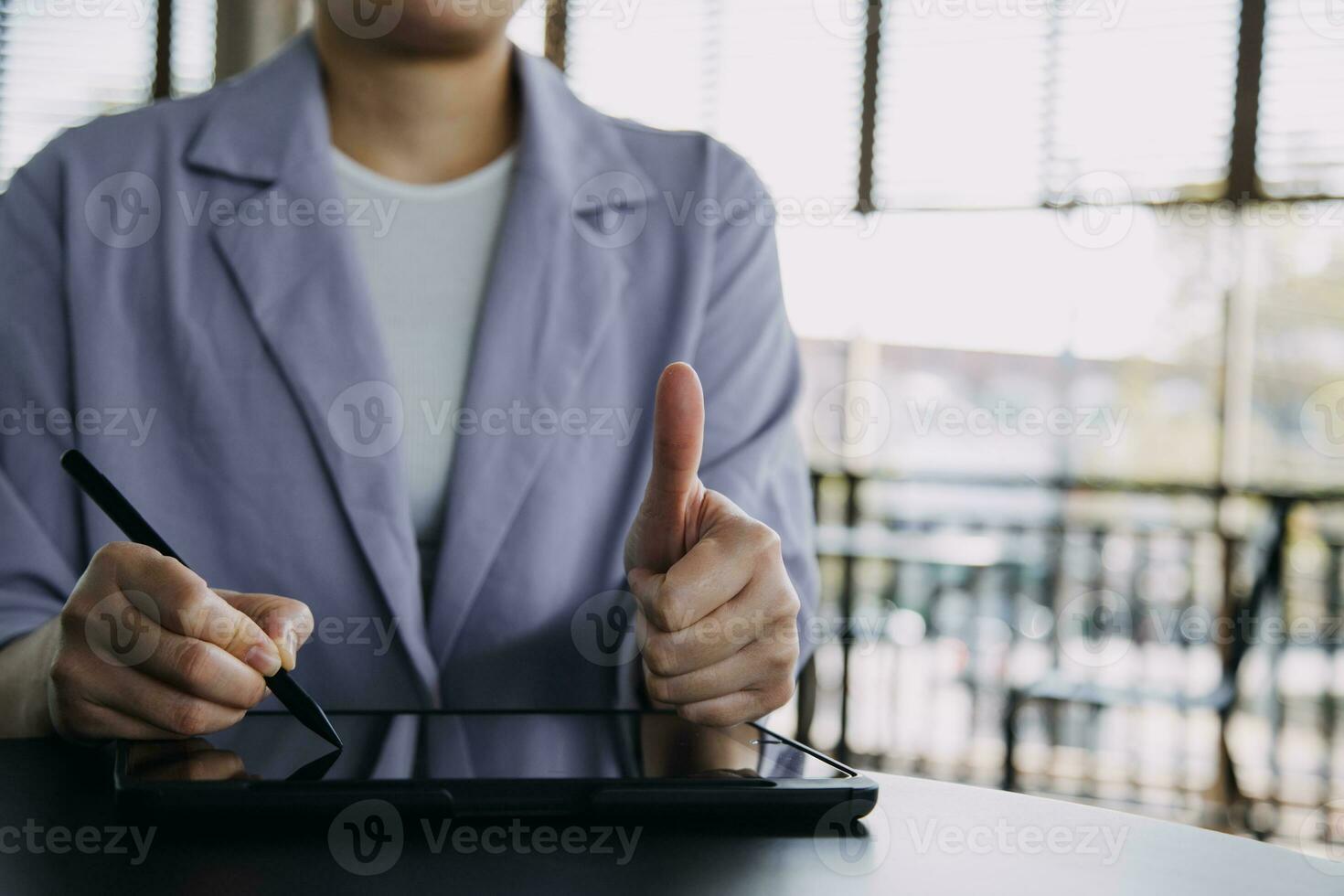 Asian Business woman using calculator and laptop for doing math finance on an office desk, tax, report, accounting, statistics, and analytical research concept photo