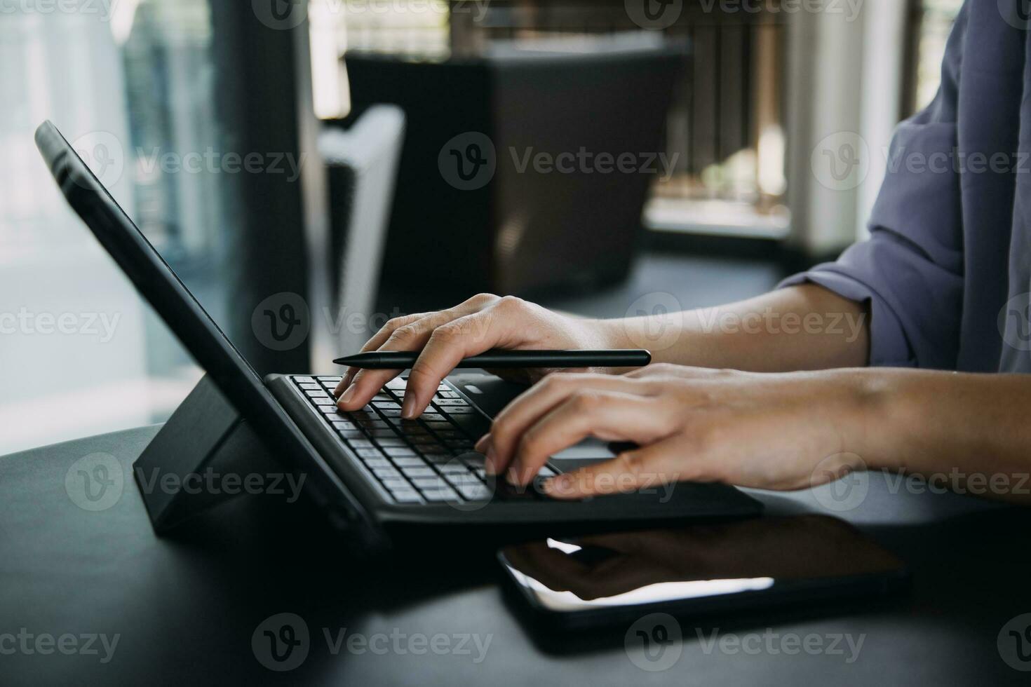 Asian Business woman using calculator and laptop for doing math finance on an office desk, tax, report, accounting, statistics, and analytical research concept photo