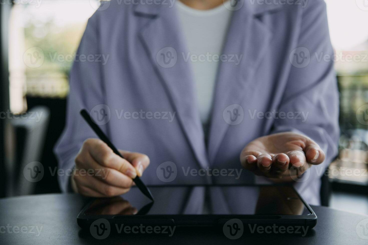 Asian Business woman using calculator and laptop for doing math finance on an office desk, tax, report, accounting, statistics, and analytical research concept photo