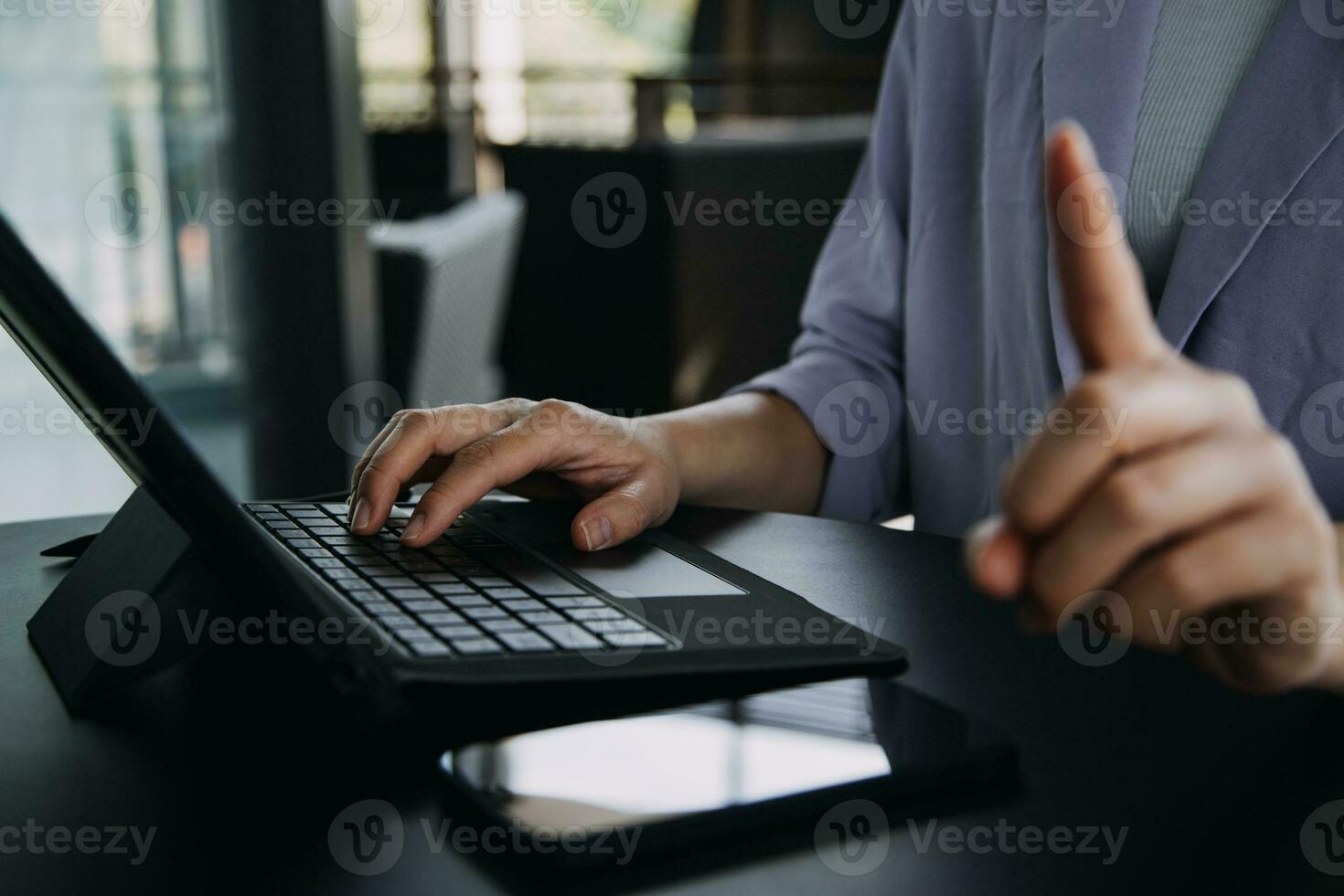 Asian Business woman using calculator and laptop for doing math finance on an office desk, tax, report, accounting, statistics, and analytical research concept photo