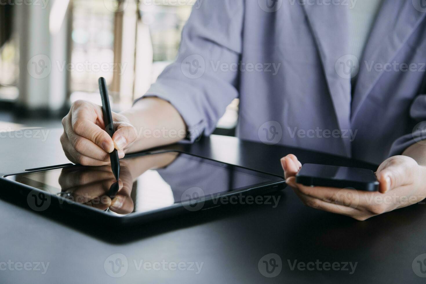 Asian Business woman using calculator and laptop for doing math finance on an office desk, tax, report, accounting, statistics, and analytical research concept photo