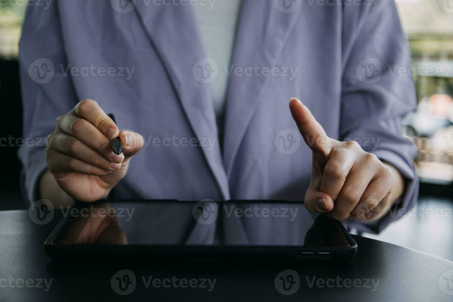 Asian Business woman using calculator and laptop for doing math finance on an office desk, tax, report, accounting, statistics, and analytical research concept photo