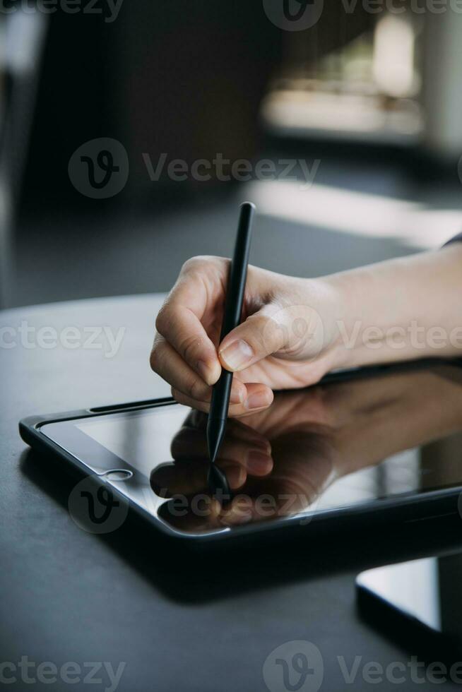 Asian Business woman using calculator and laptop for doing math finance on an office desk, tax, report, accounting, statistics, and analytical research concept photo