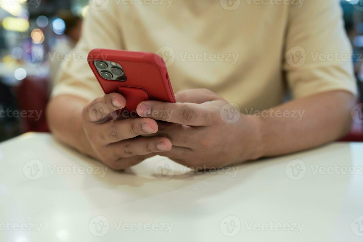 Relaxed young asian man using smart phone  spending time checking news social media. photo