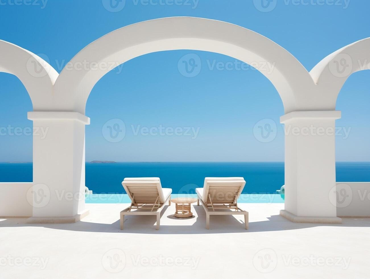 Two sunbeds on the white terrace with an arch under blue clear sky photo