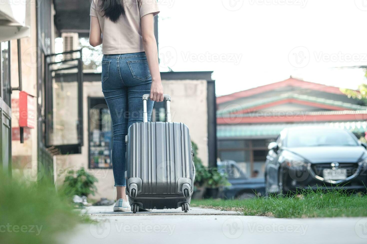 Traveler woman carrying luggage. Tourist walking with Suitcases Travel lifestyle concept. photo