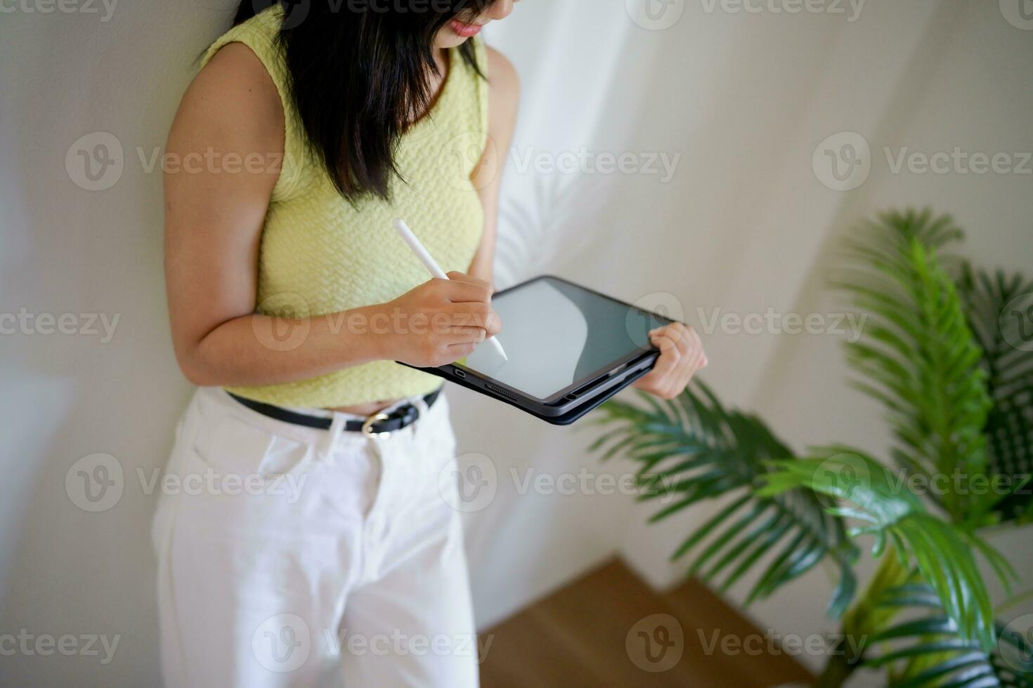 Happy young Asian Woman Successful Business woman creative using digital tablet standing in office. photo