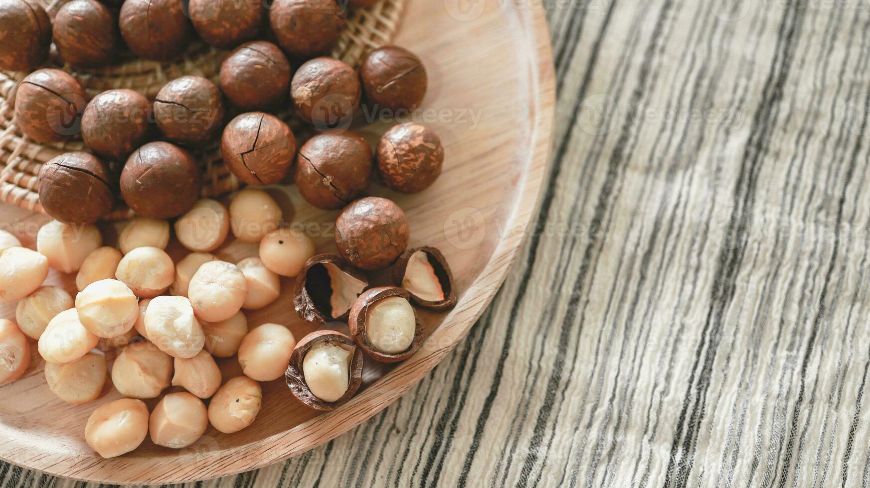 Organic Macadamia nut. macadamia nuts are cracked and baked to taste extremely delicious superfood fresh natural shelled unsalted raw macadamia and healthy food concept photo