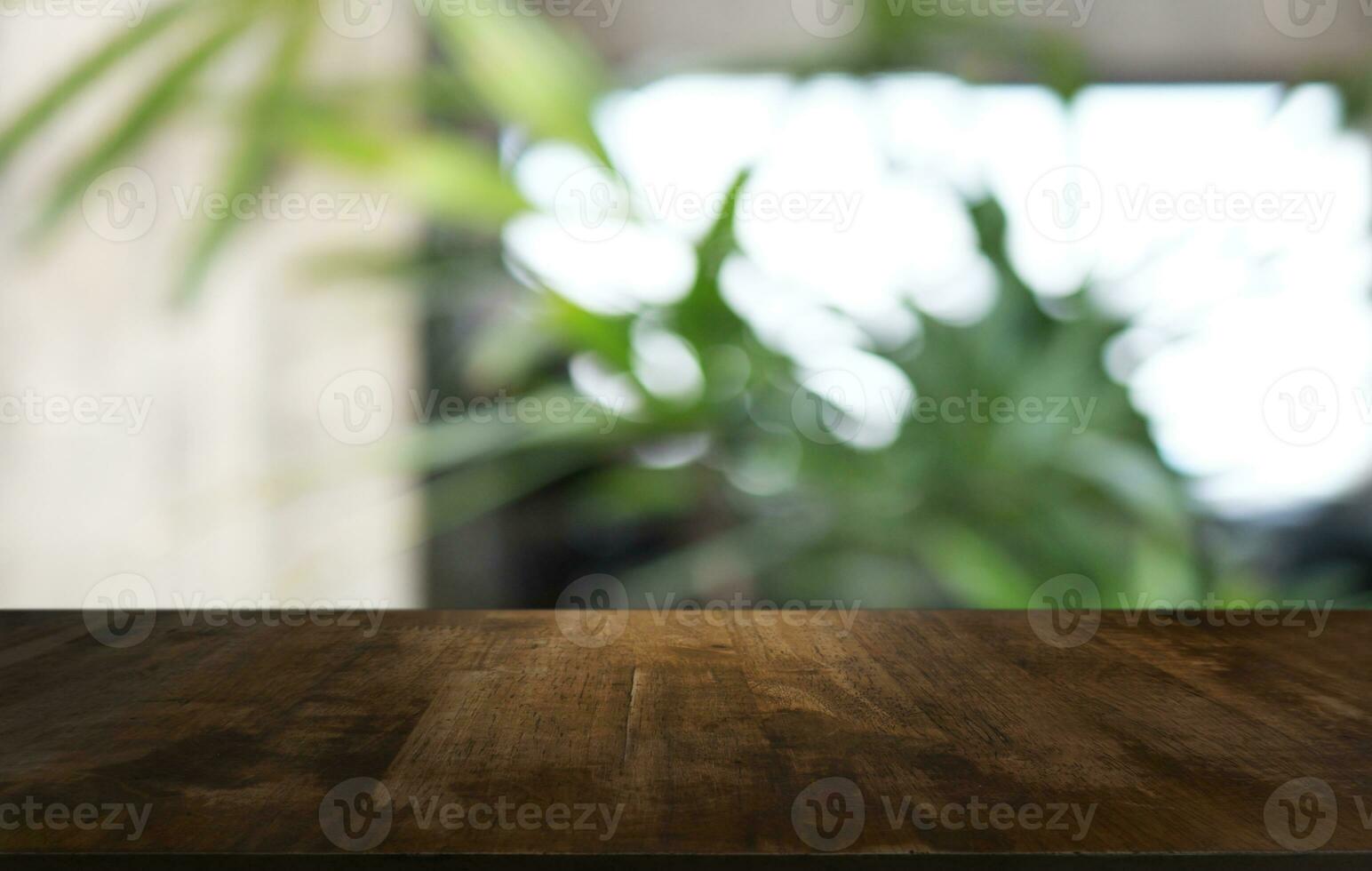 Wood Table Top in Blur Background room interior with empty copy space. photo