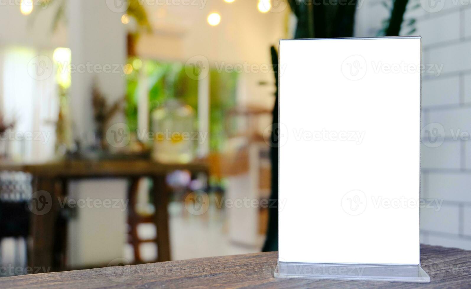 Mock up Menu frame standing on wood table in Bar restaurant cafe. space for text photo