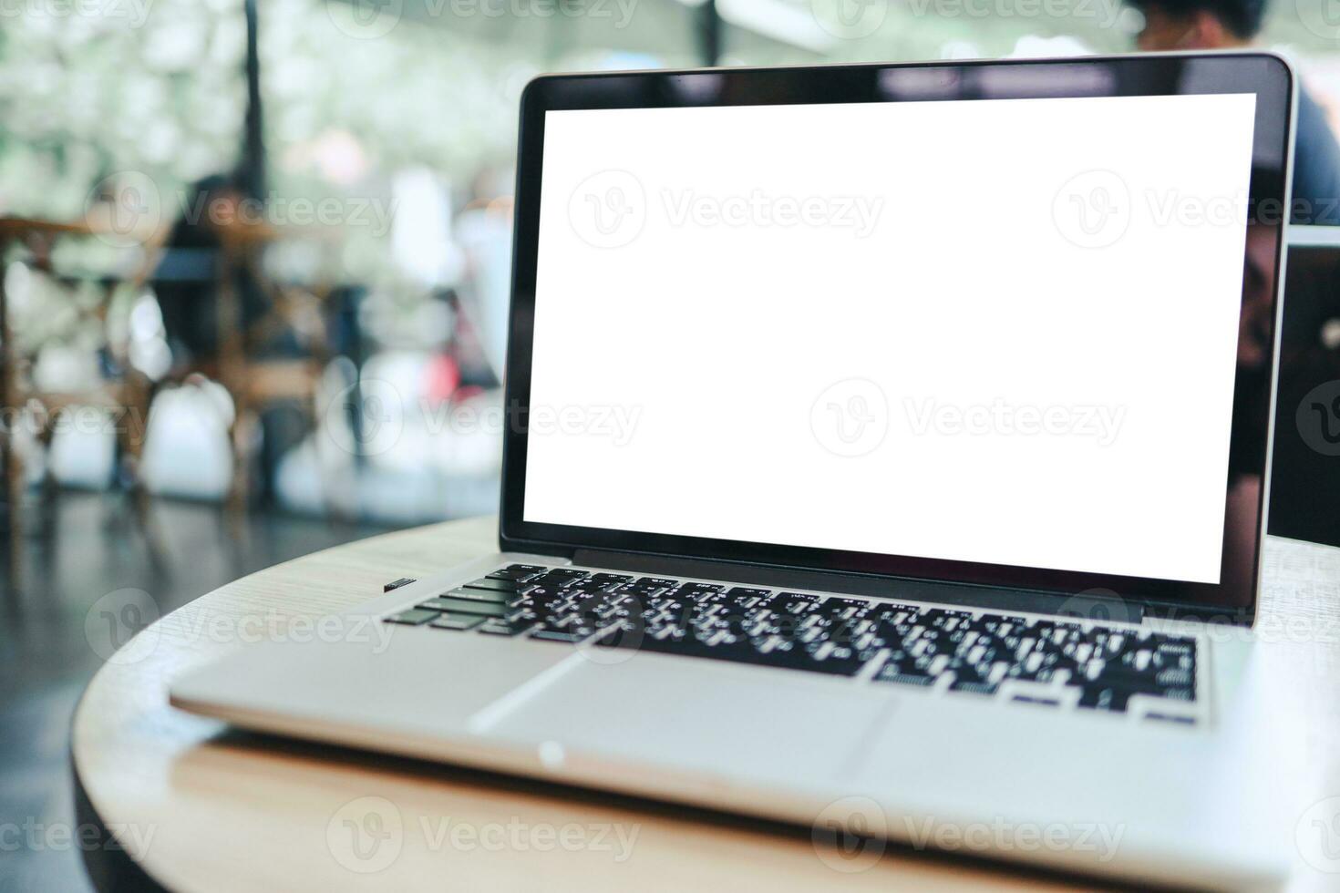 Laptop with Mock up blank screen on wooden table in front of cafe space for text. product display montage- technology concept. photo