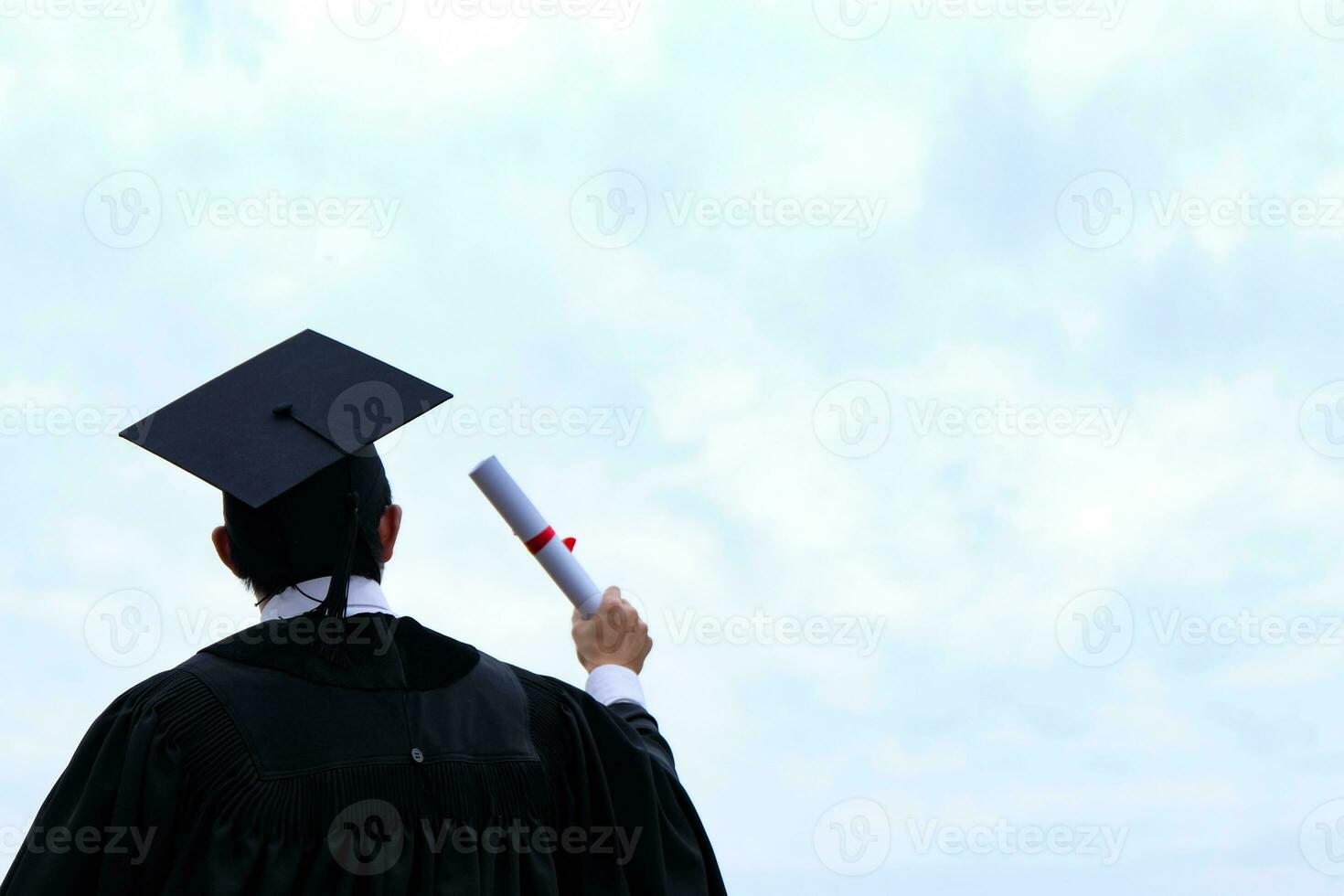 Student with congratulations, graduates wearing a graduation gown of university. photo