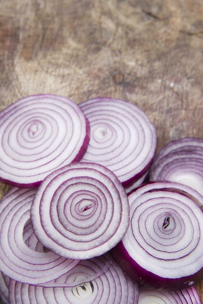 a knife and a bunch of onions on a cutting board photo