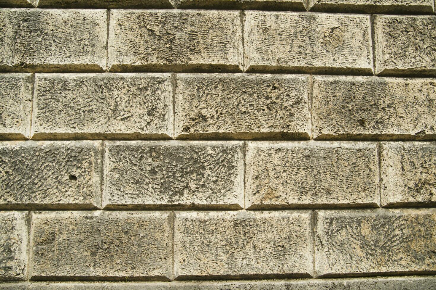 a close up of a brick wall with a few squares photo