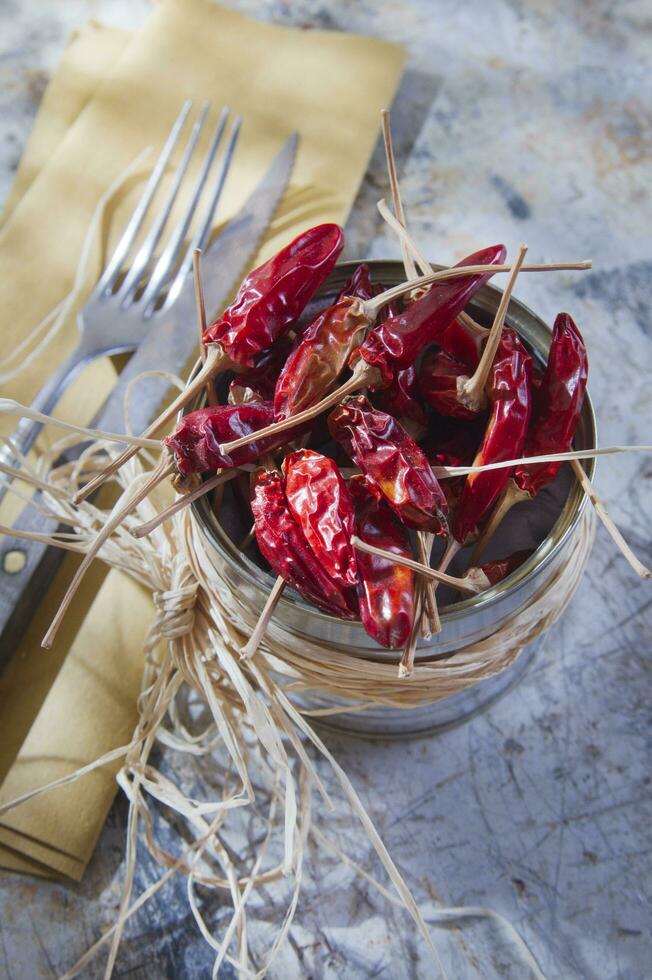 a silver container with dried red peppers photo