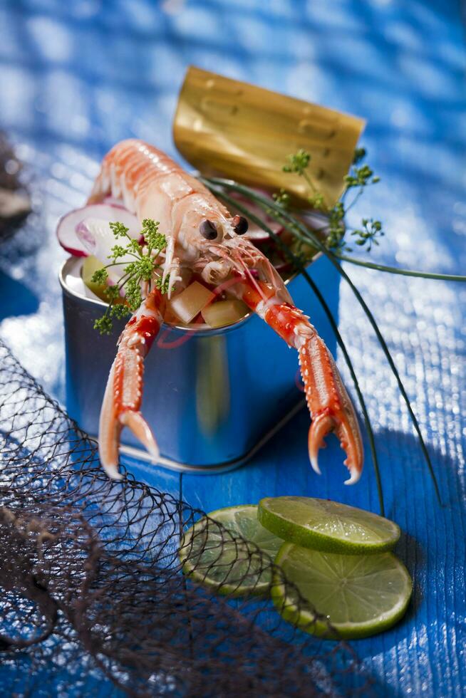 a shrimp in a container with a lime on a blue table photo