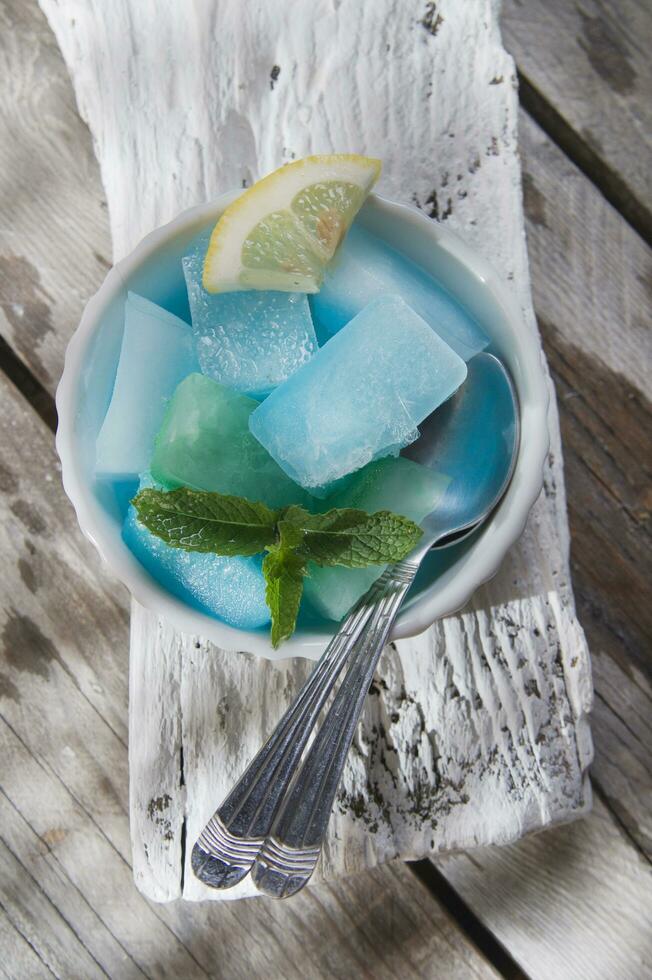 Bowl of colored ice-cubes photo