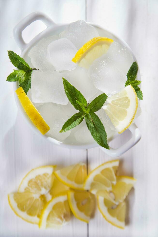 ice cubes in a bowl with a leaf on top photo