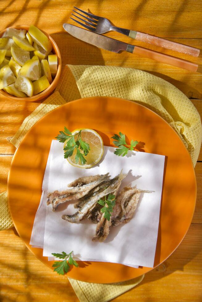 a plate of fish with a fork and knife on it photo