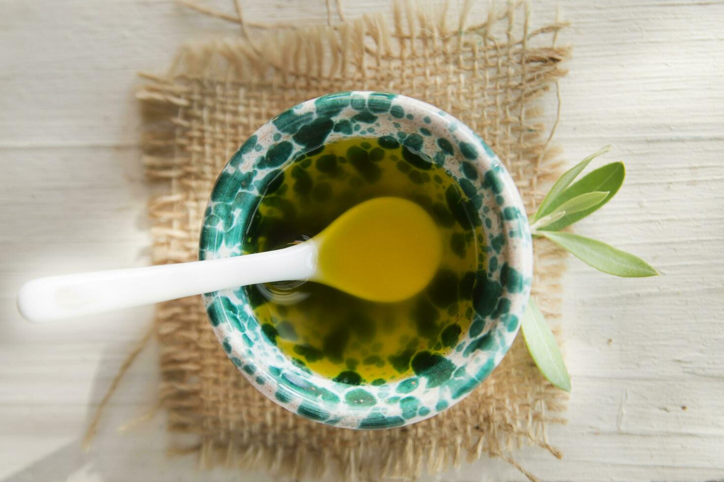 Small container with extra virgin olive oil photo