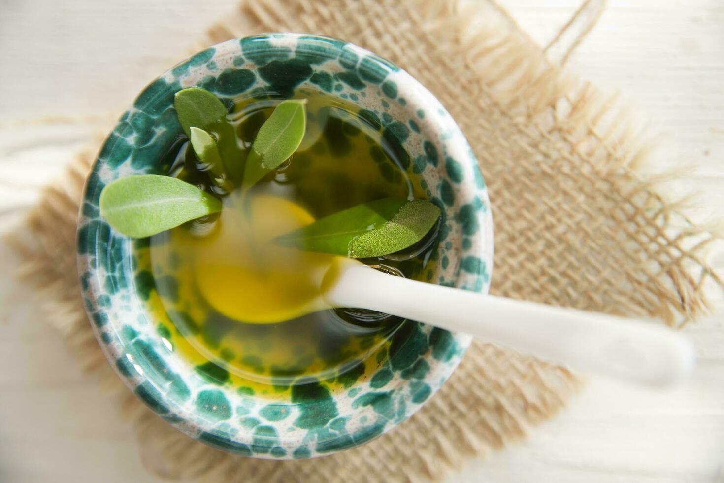 Small container with extra virgin olive oil photo