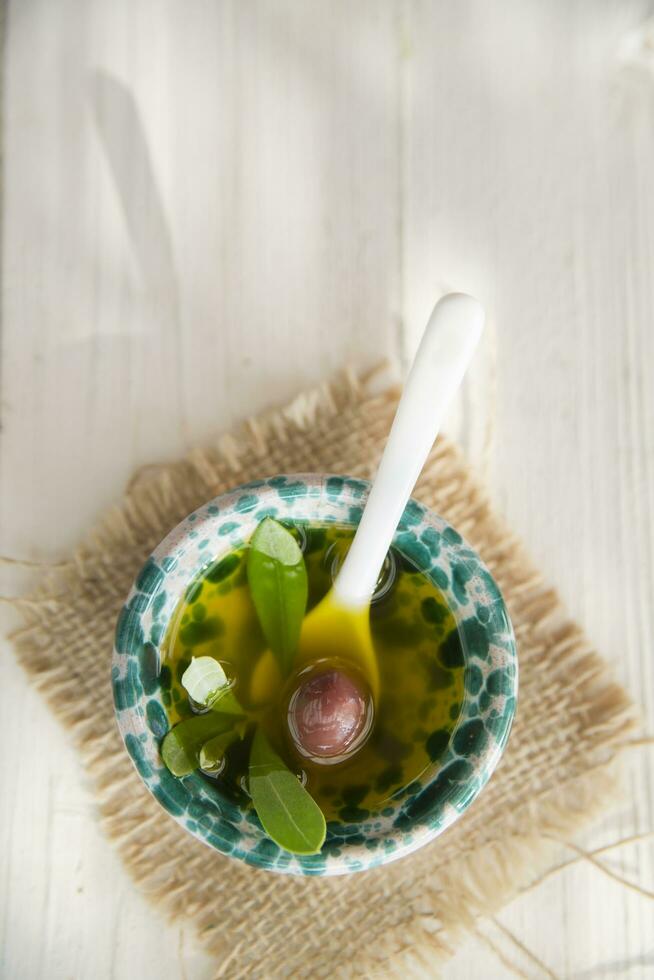 Small container with extra virgin olive oil photo