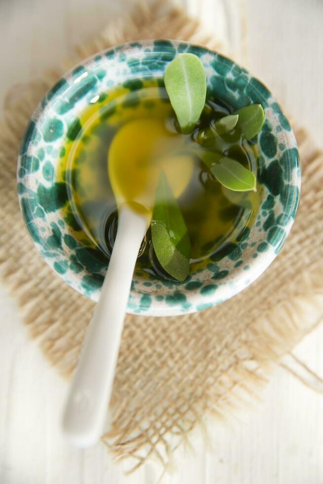 Small container with extra virgin olive oil photo