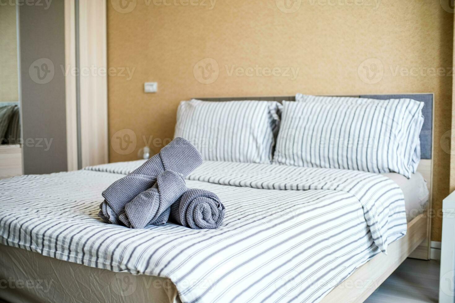 Clean stack of towels in hotel bedroom. photo