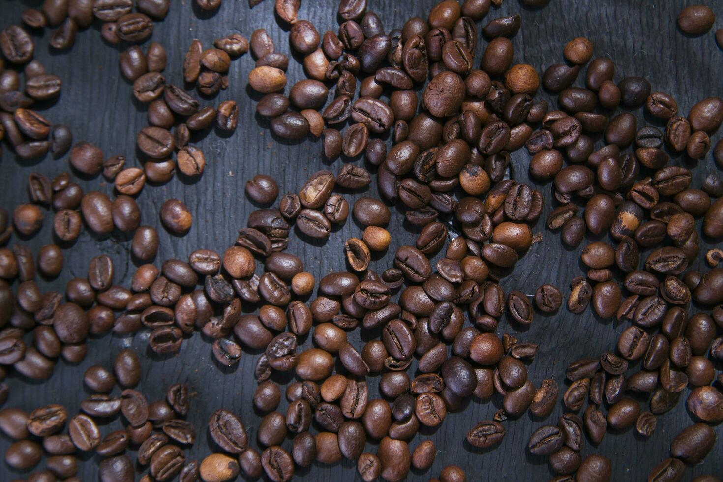 coffee beans are scattered on a table photo