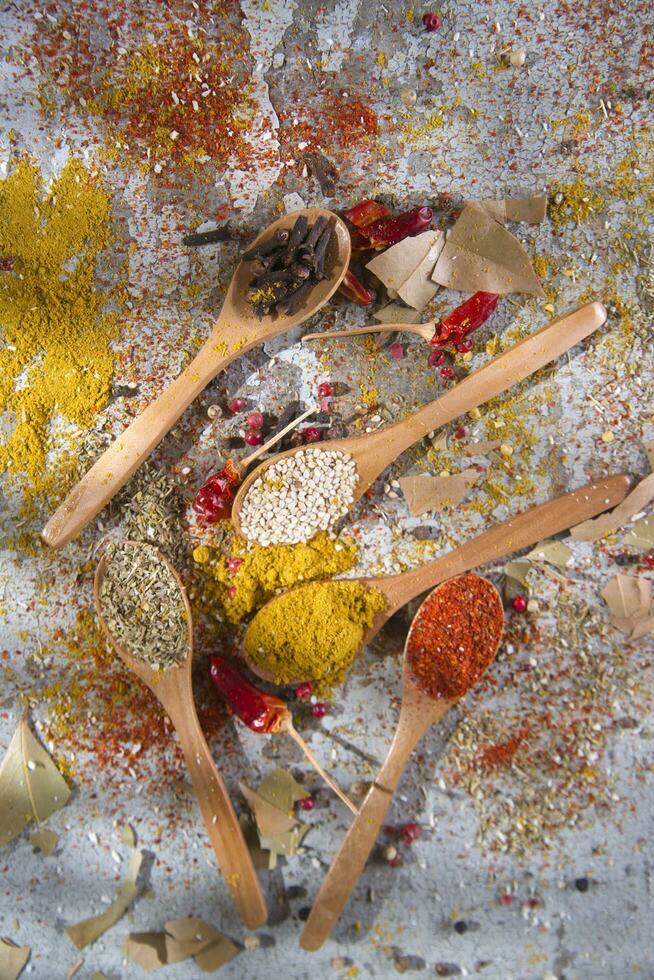 a wooden spoon with spices and other ingredients photo