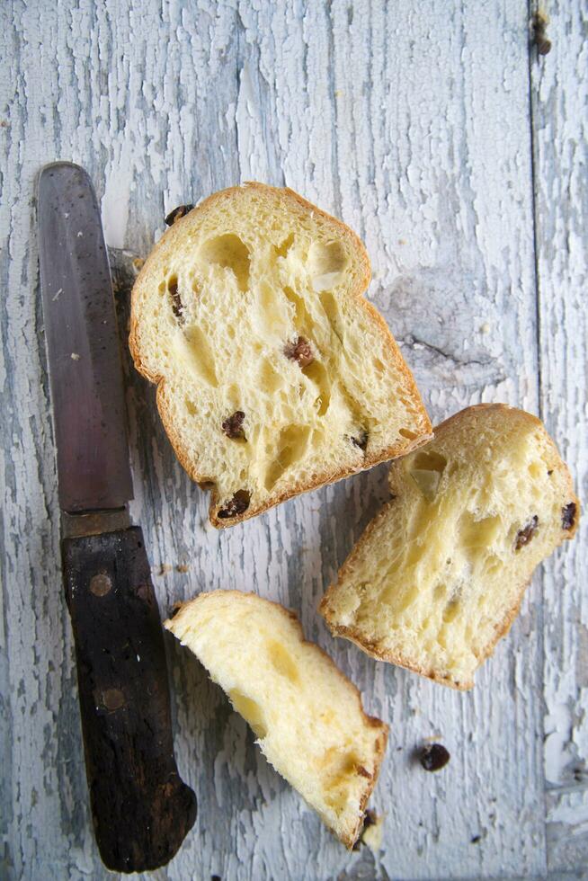 a knife and a piece of bread on a table photo