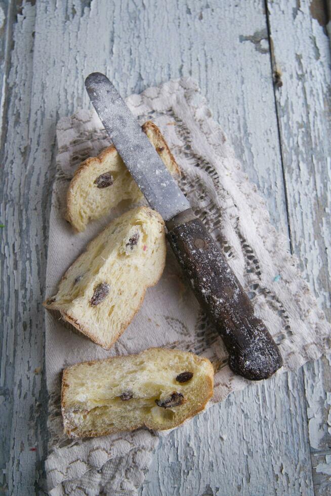 a knife and a piece of bread on a table photo