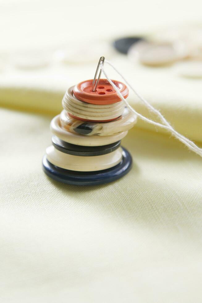a pile of buttons on a white table photo