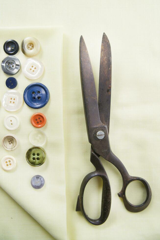 a pile of buttons on a white table photo