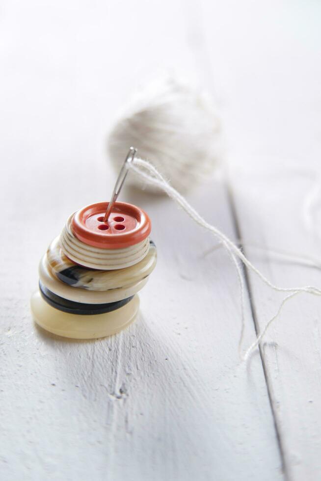 a pile of buttons on a white table photo