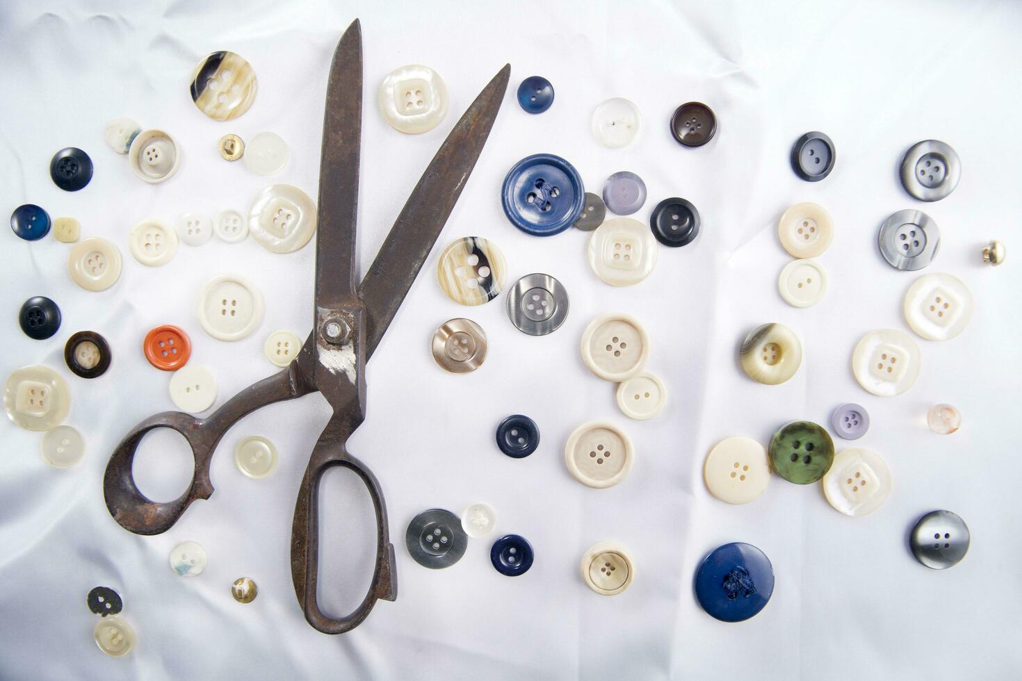 a pile of buttons on a white table photo