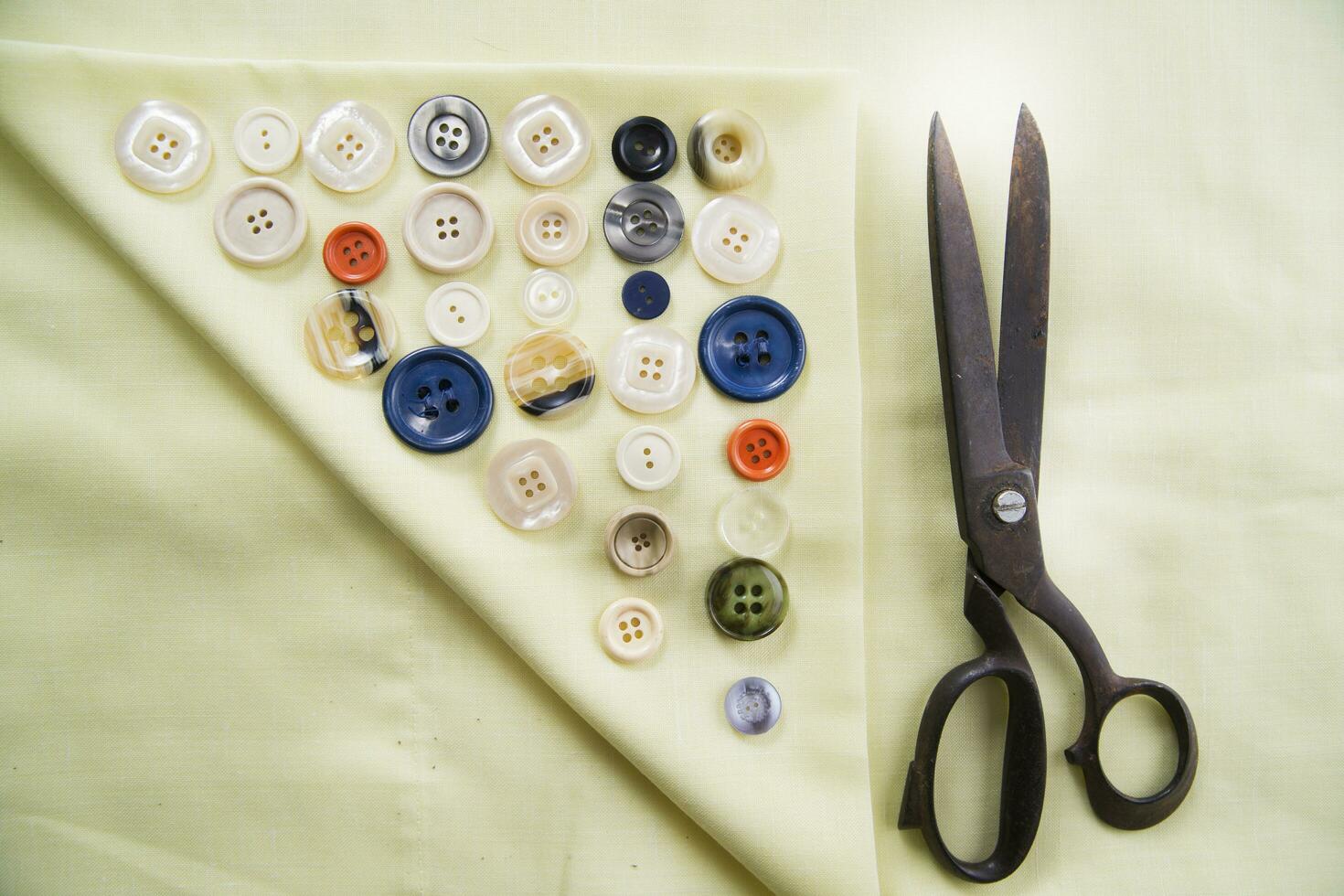 a pile of buttons on a white table photo