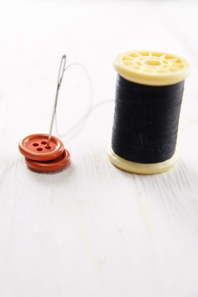 a pile of buttons on a white table photo