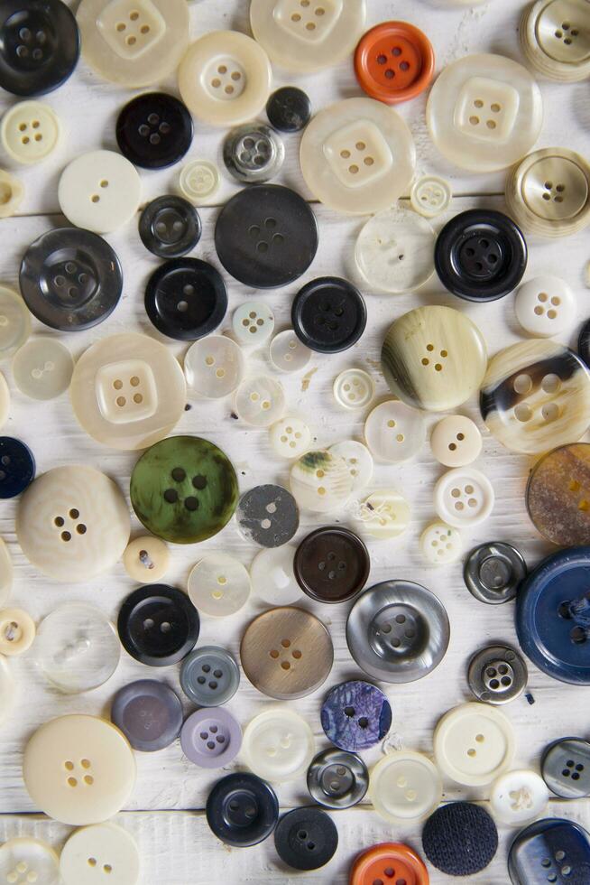 a pile of buttons on a white table photo