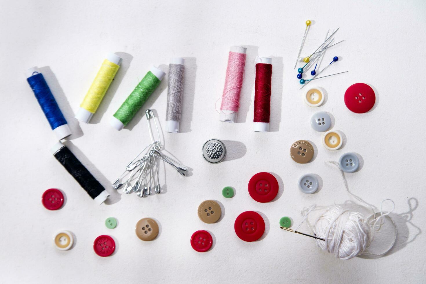a pile of buttons on a white table photo